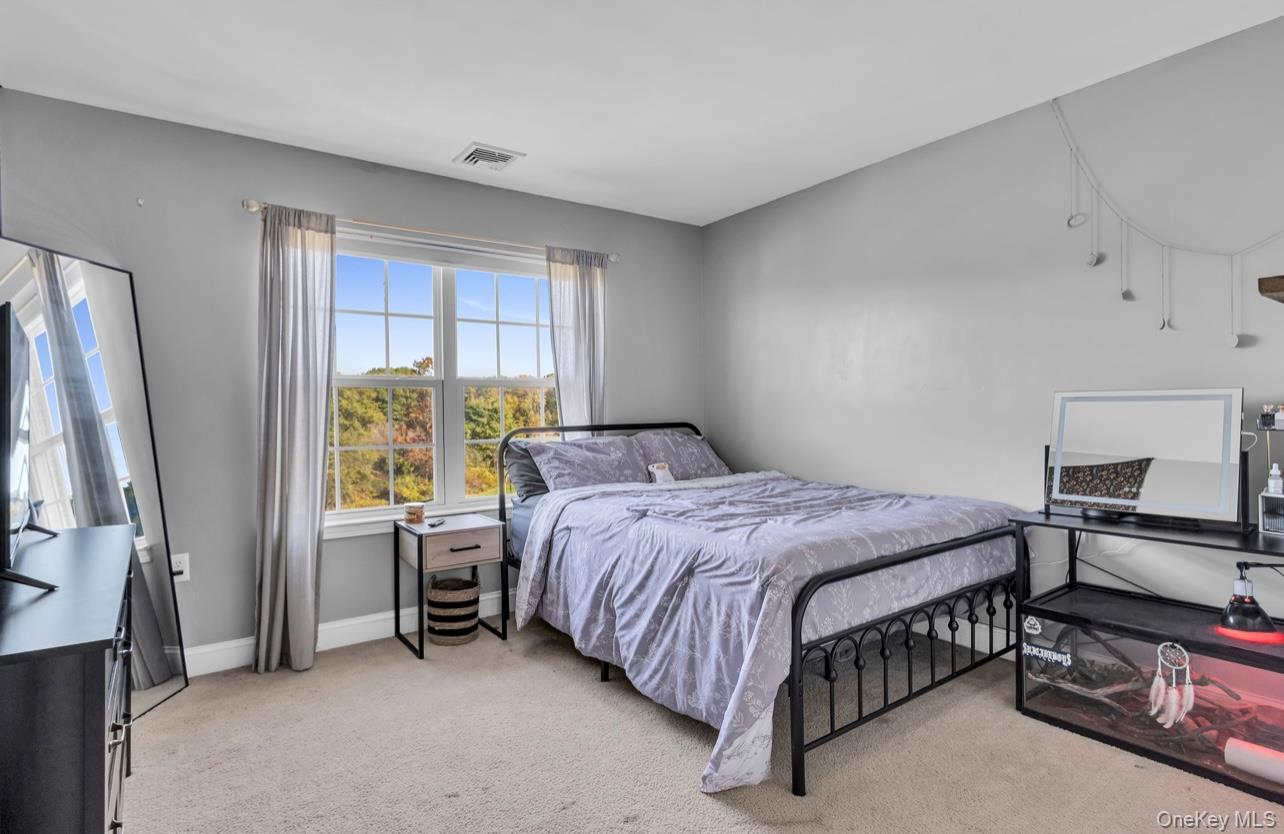 59 Luthien Forrest Road Rock Tavern, NY 12575 - Photo 34 of 48 a bedroom with a bed and a window