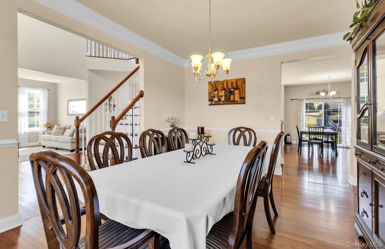 59 Luthien Forrest Road Rock Tavern, NY 12575 - Photo 9 of 48 a view of a dining room and livingroom with furniture wooden floor a chandelier
