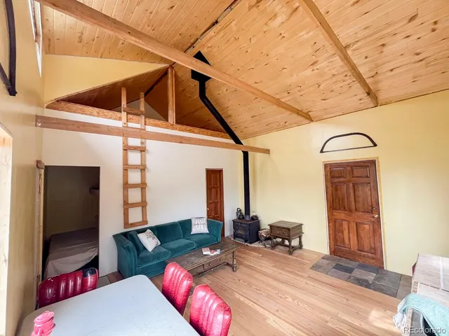 a bedroom with furniture and a wooden floor