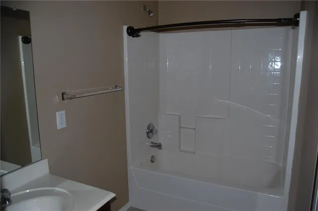 a bathroom with a shower and a toilet