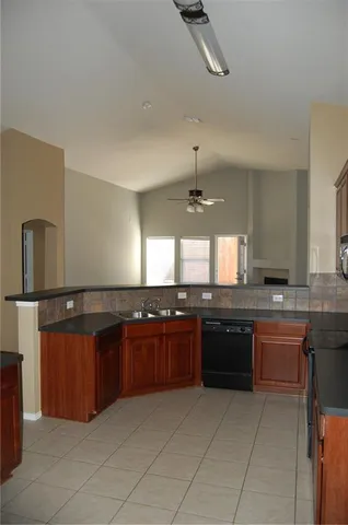 a large kitchen with a stove top oven and sink