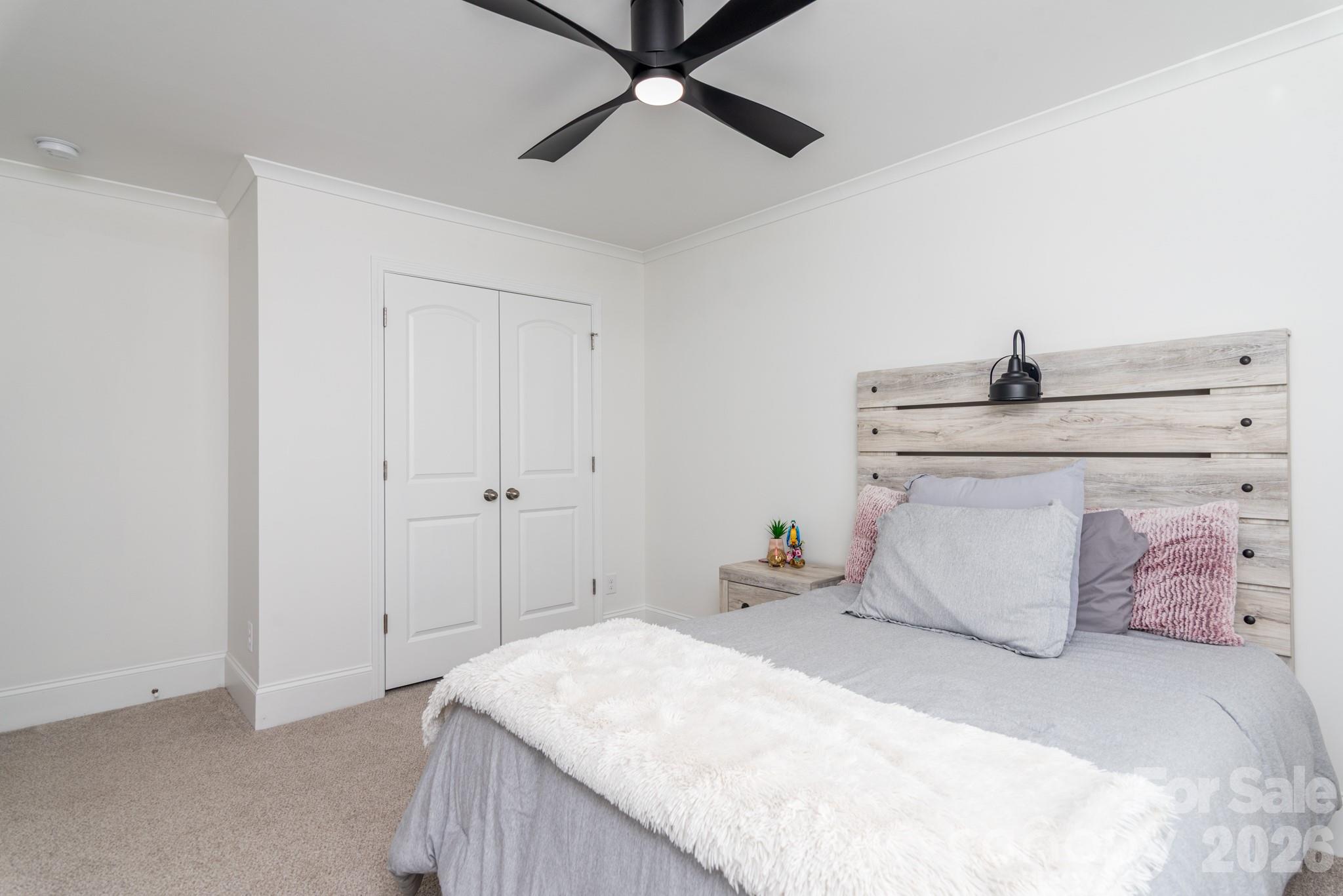16629 Summers Walk Boulevard Davidson, NC 28036 - Photo 18 of 29 a bedroom with a bed and a ceiling fan