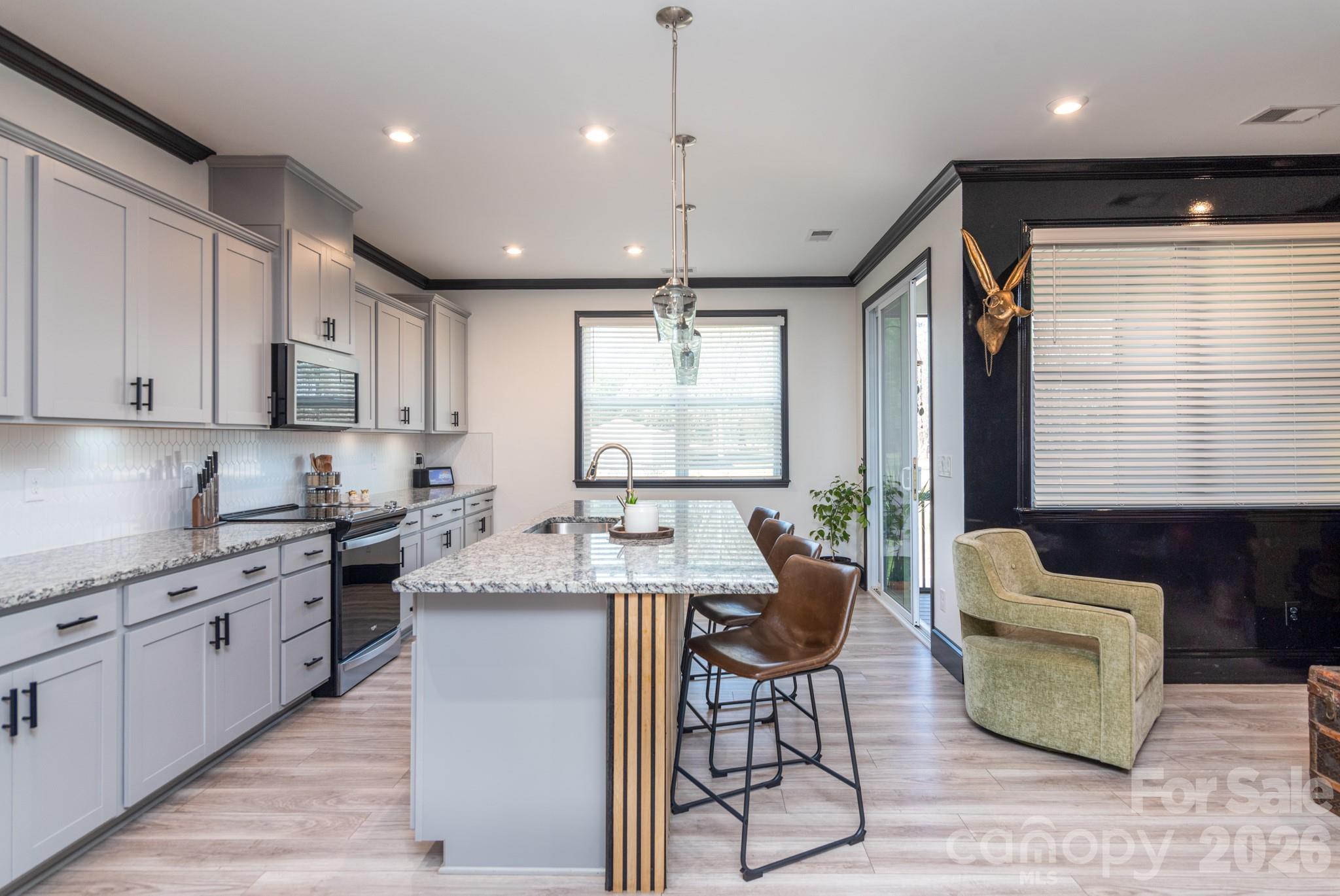 16629 Summers Walk Boulevard Davidson, NC 28036 - Photo 6 of 29 a kitchen with stainless steel appliances granite countertop sink stove top oven and cabinets