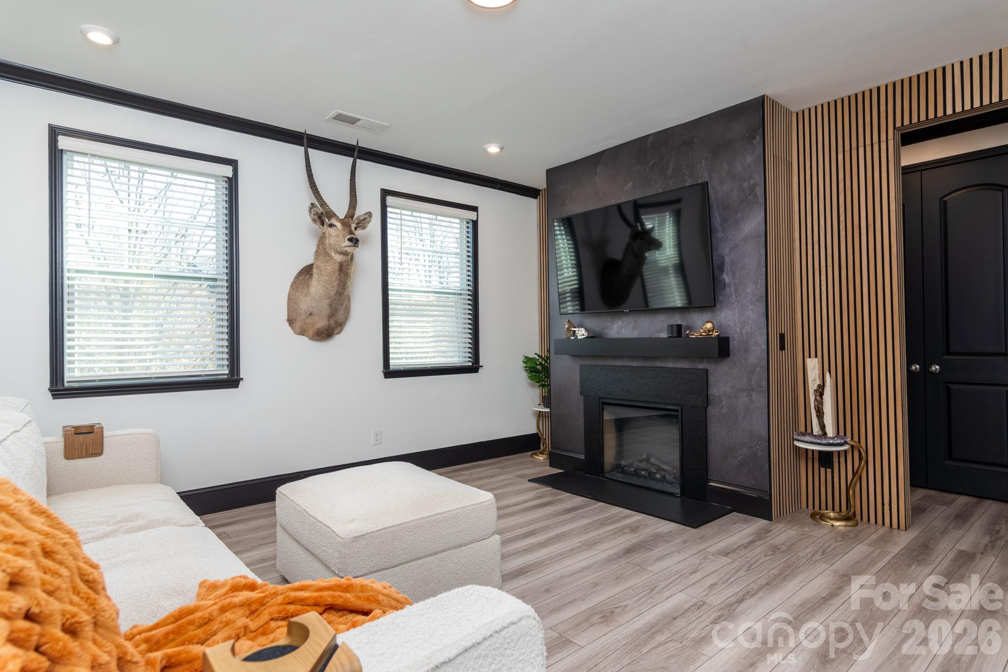 16629 Summers Walk Boulevard Davidson, NC 28036 - Photo 7 of 29 a bedroom with furniture and a fireplace
