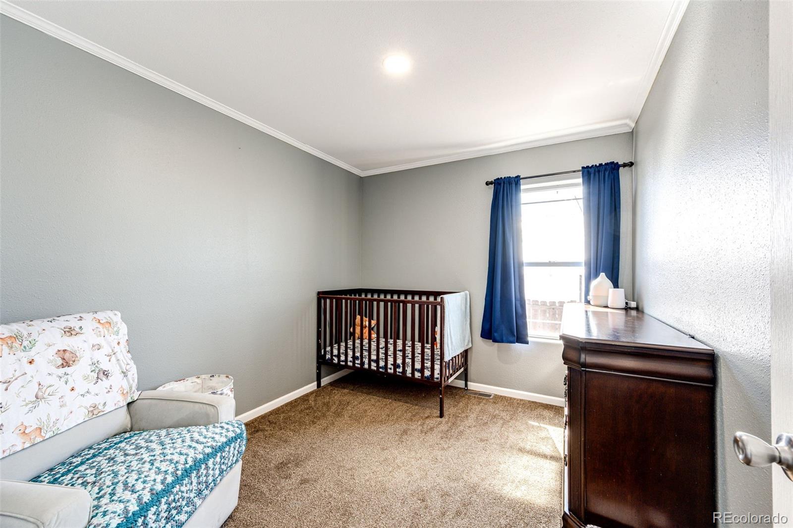 570 4th Street Bennett, CO 80102 - Photo 21 of 36 a bedroom with furniture and window