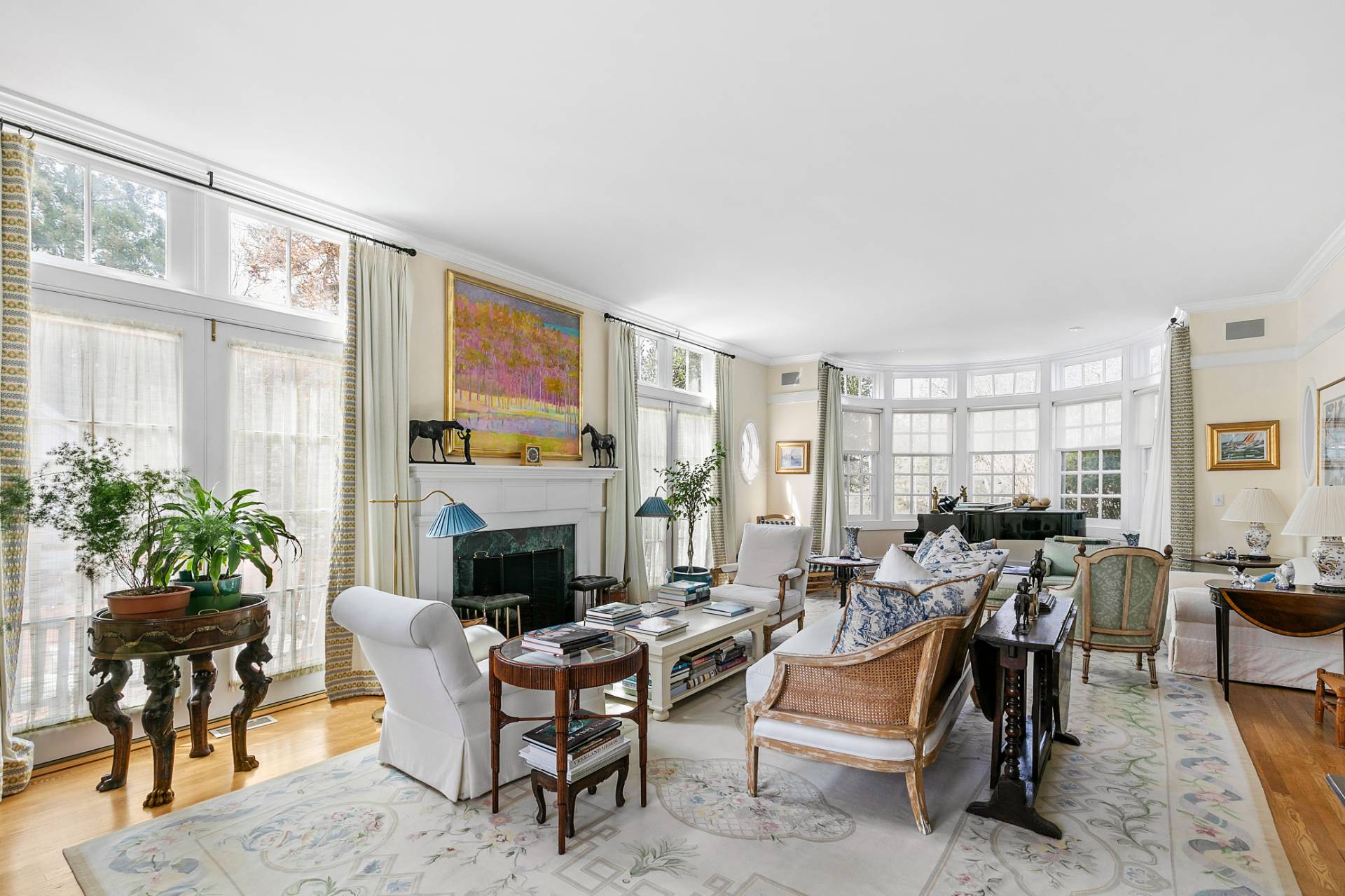 a living room with furniture large window and a fireplace