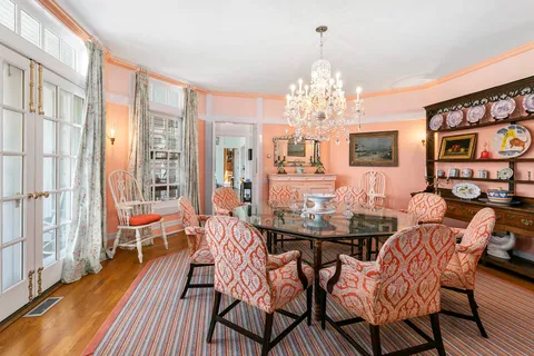 a view of a dining room with furniture and chandelier
