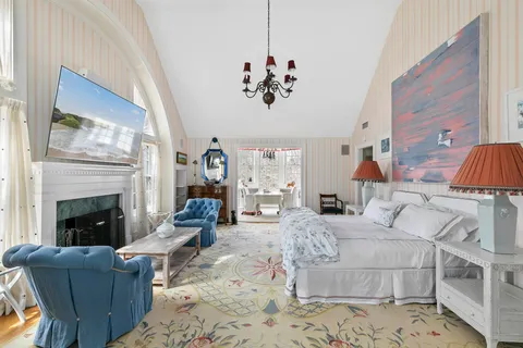 a living room with furniture a fireplace and a chandelier