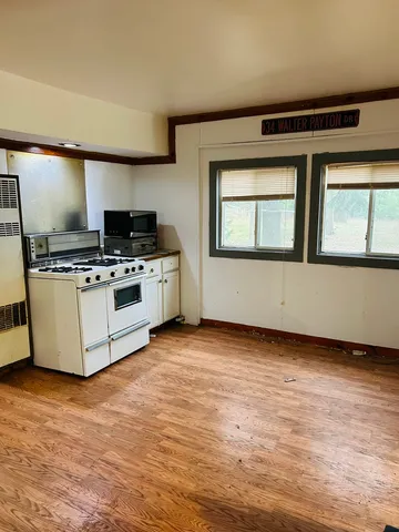 a kitchen with a stove and a microwave