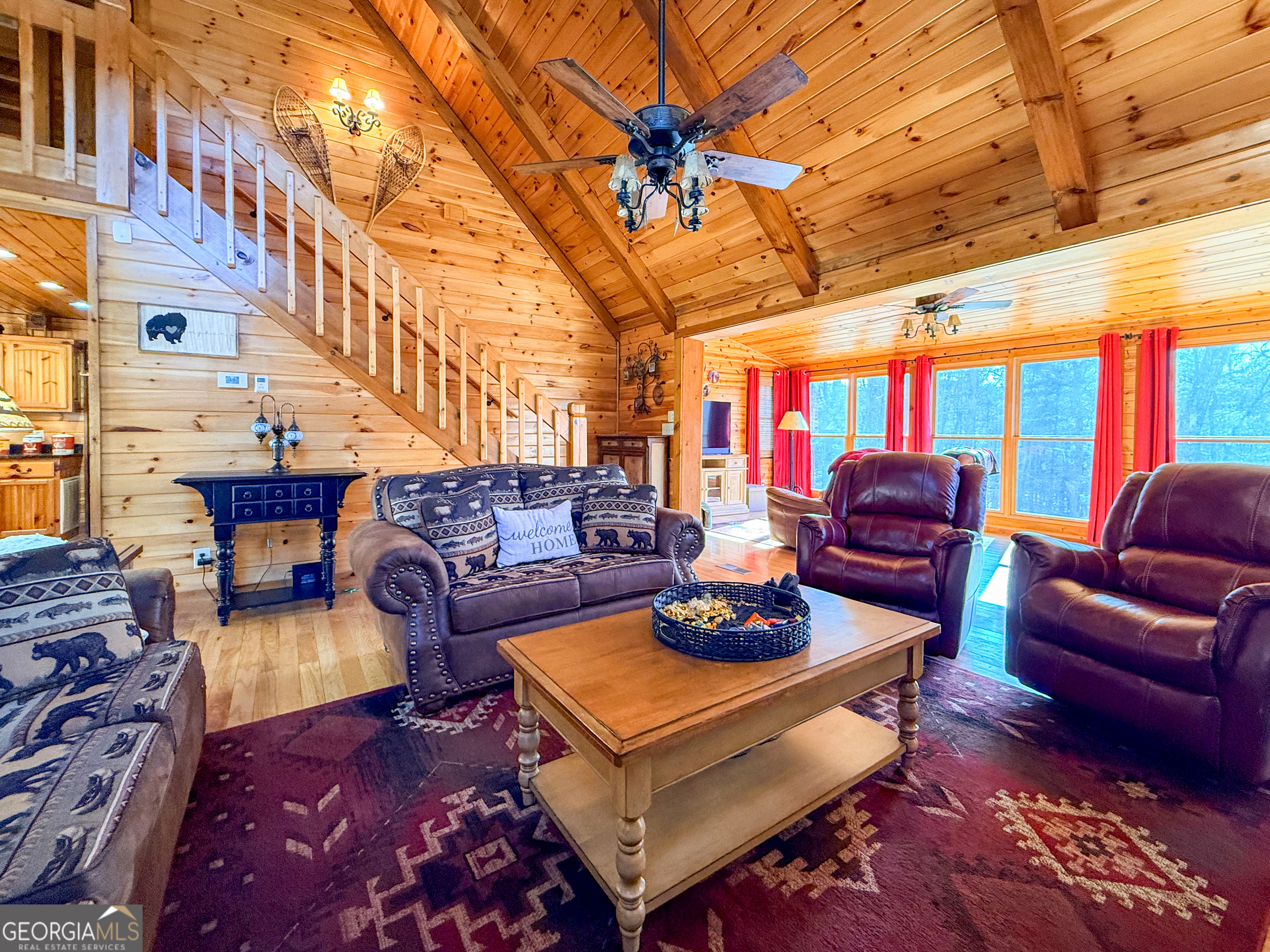 202 Shepherds Ridge Morganton, GA 30560 - Photo 13 of 74 a living room with furniture a rug and a chandelier