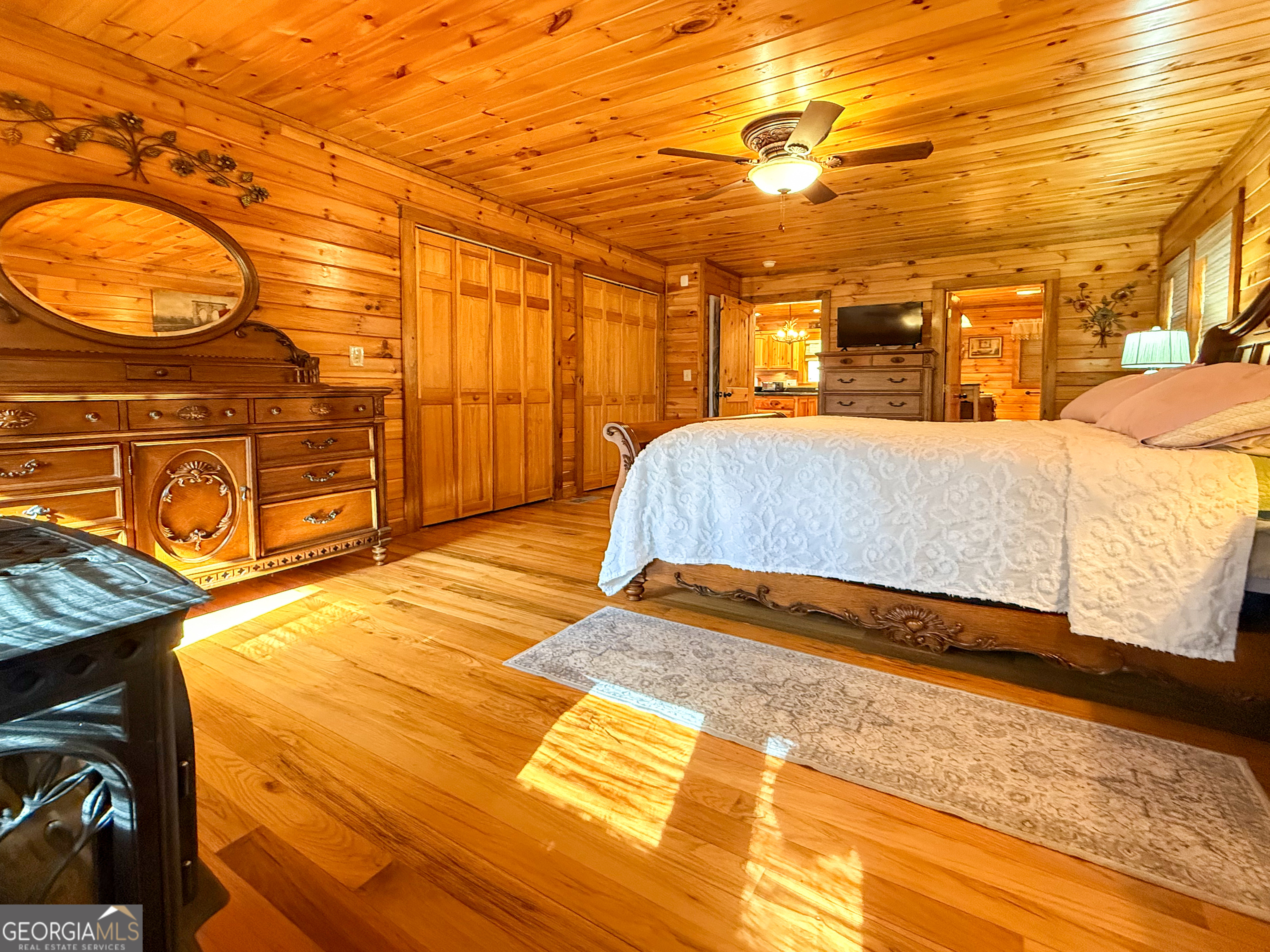202 Shepherds Ridge Morganton, GA 30560 - Photo 21 of 74 a bedroom with a bed and closet with wooden floor