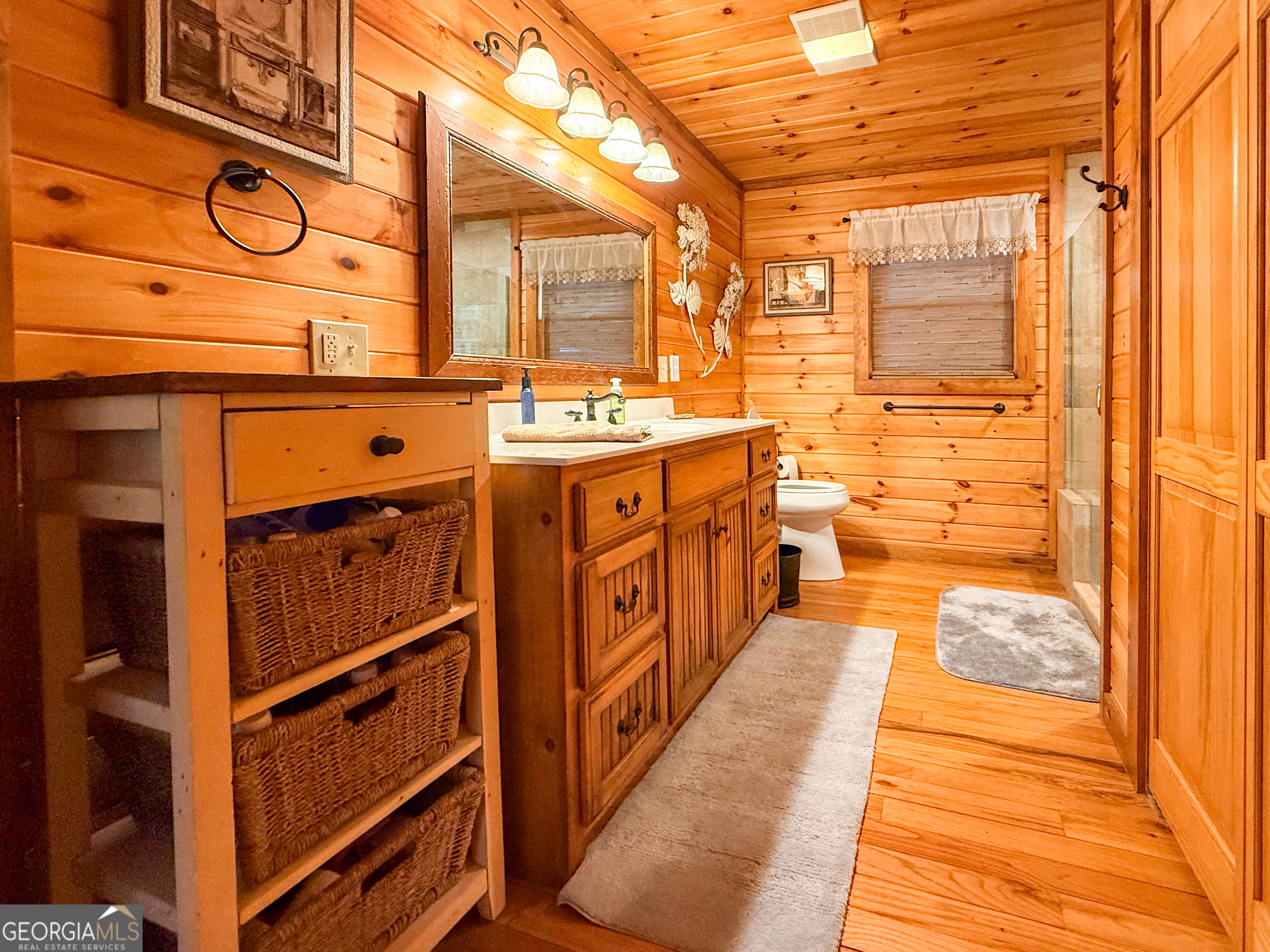 202 Shepherds Ridge Morganton, GA 30560 - Photo 22 of 74 a bathroom with a sink a mirror and a shower