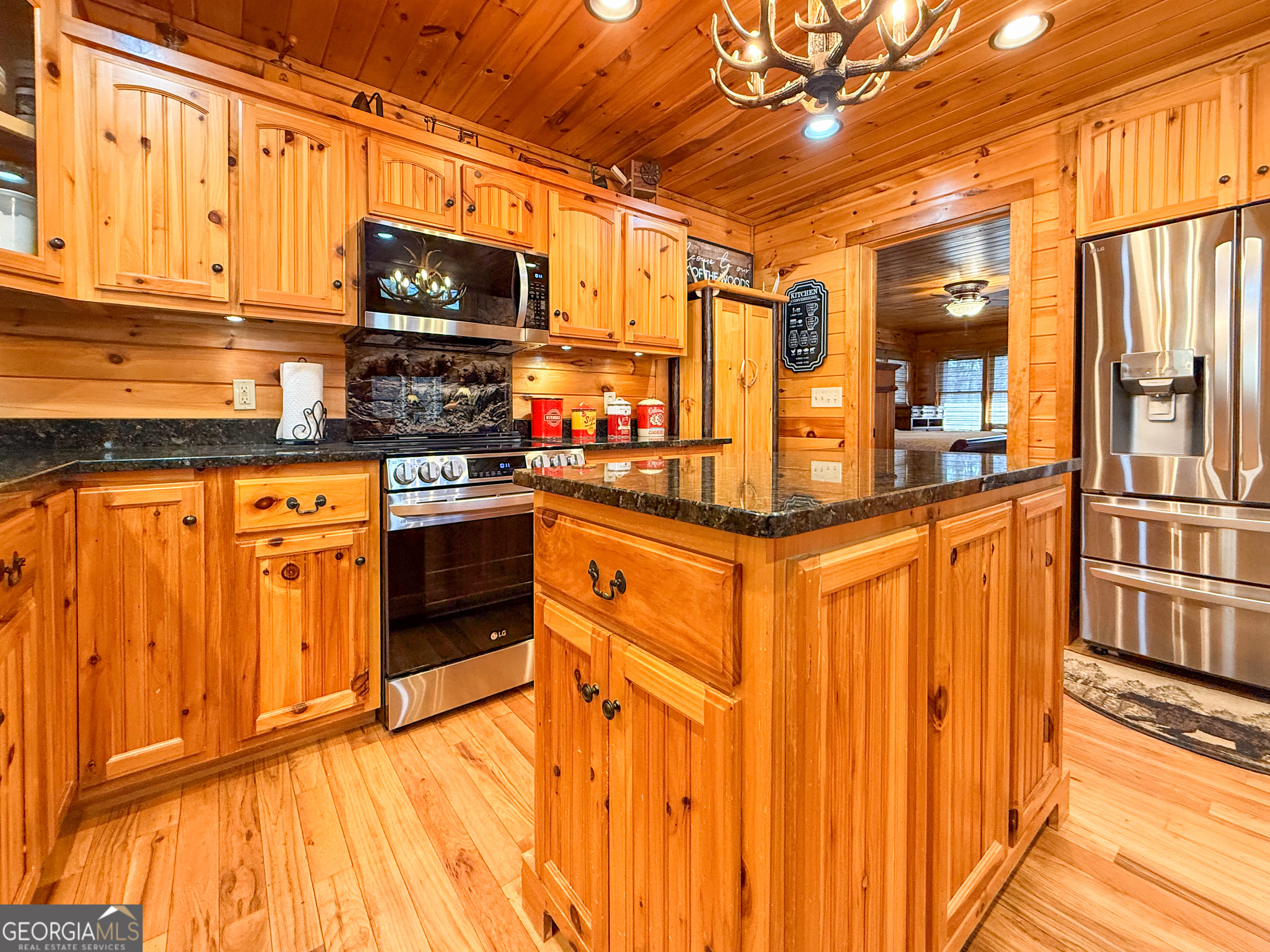 202 Shepherds Ridge Morganton, GA 30560 - Photo 8 of 74 a kitchen with stainless steel appliances granite countertop a stove top oven a sink dishwasher and cabinets with wooden floor
