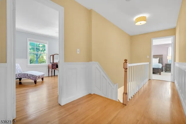 a view of a livingroom with wooden floor and furniture
