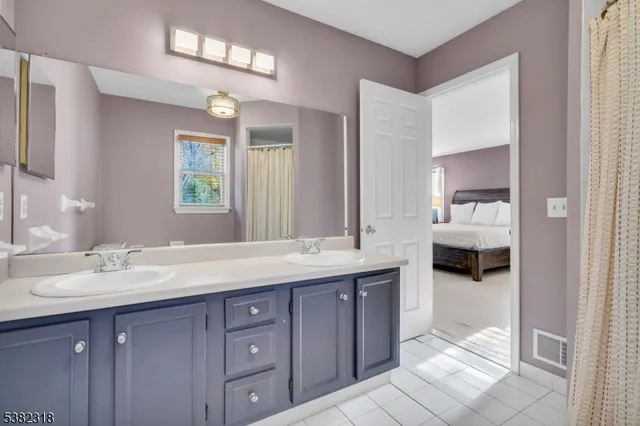 a en suite bathroom with double sink and a mirror