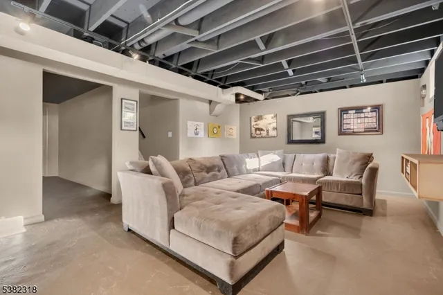 a living room with furniture and a chandelier