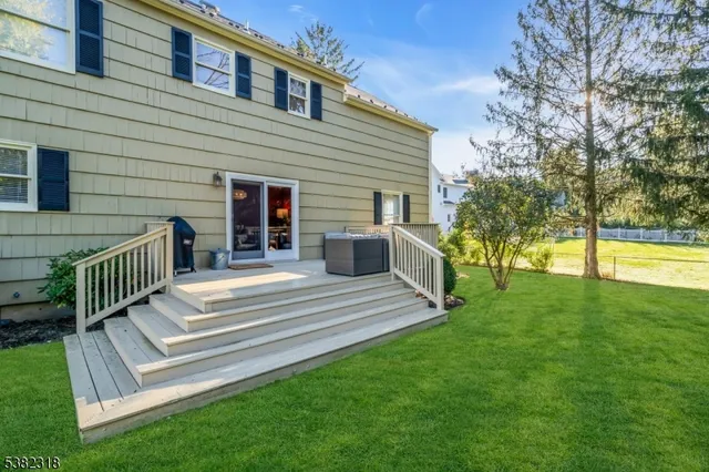 a view of a house with a yard and deck
