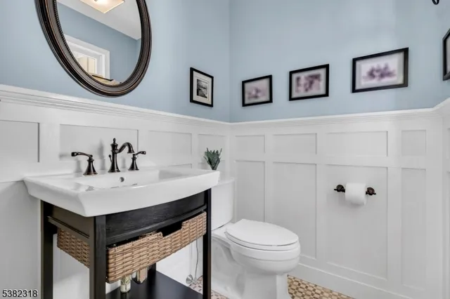 a bathroom with a sink a mirror and a toilet