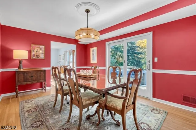 a view of a dining room with furniture wooden floor and chandelier