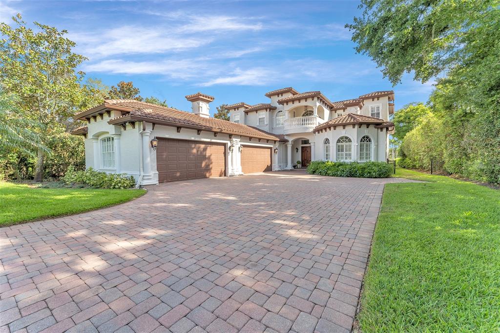 3308 South Lake Butler Boulevard Windermere, FL 34786 - Photo 1 of 1 a front view of a house with a yard and trees
