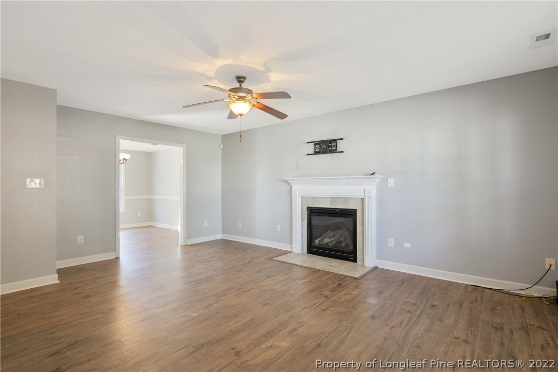 234 Pender Road Spring Lake, NC 28390 - Photo 7 of 50 a view of an empty room with a fireplace and a window