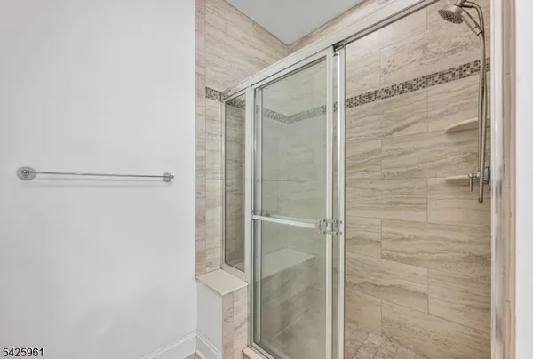 a bathroom with a glass shower door