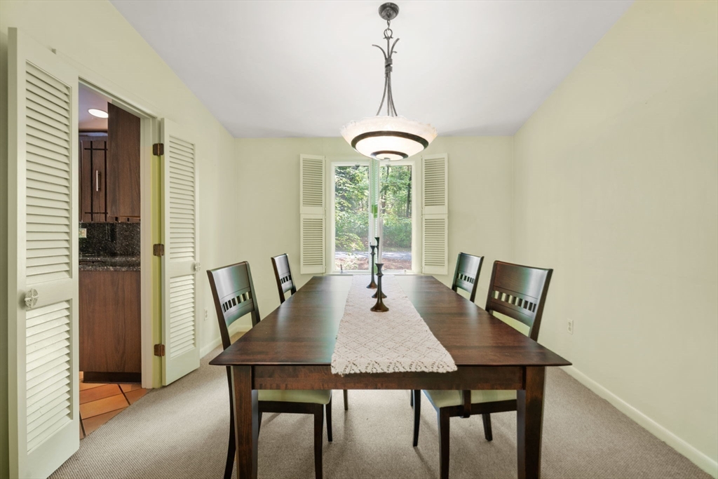 23 Indian Ridge Road Natick, MA 01760 - Photo 13 of 40 a view of a dining room with a table and chairs