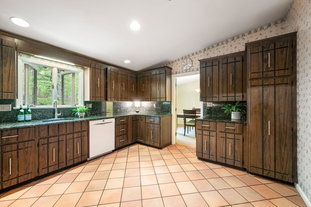 23 Indian Ridge Road Natick, MA 01760 - Photo 16 of 40 a kitchen with stainless steel appliances granite countertop a refrigerator and a sink