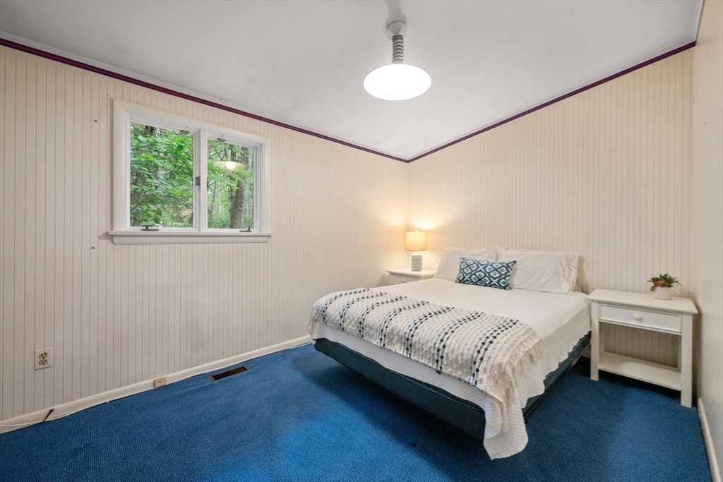 23 Indian Ridge Road Natick, MA 01760 - Photo 18 of 40 a bedroom with a bed and a chandelier