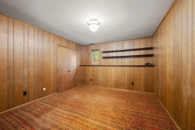 a view of a room with an empty space and wooden floor