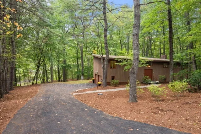 a backyard of a house with table and chairs