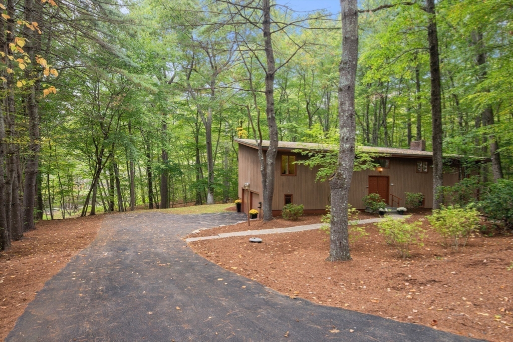 23 Indian Ridge Road Natick, MA 01760 - Photo 38 of 40 a backyard of a house with table and chairs