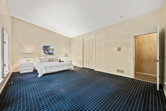 a bedroom with a bed and a table