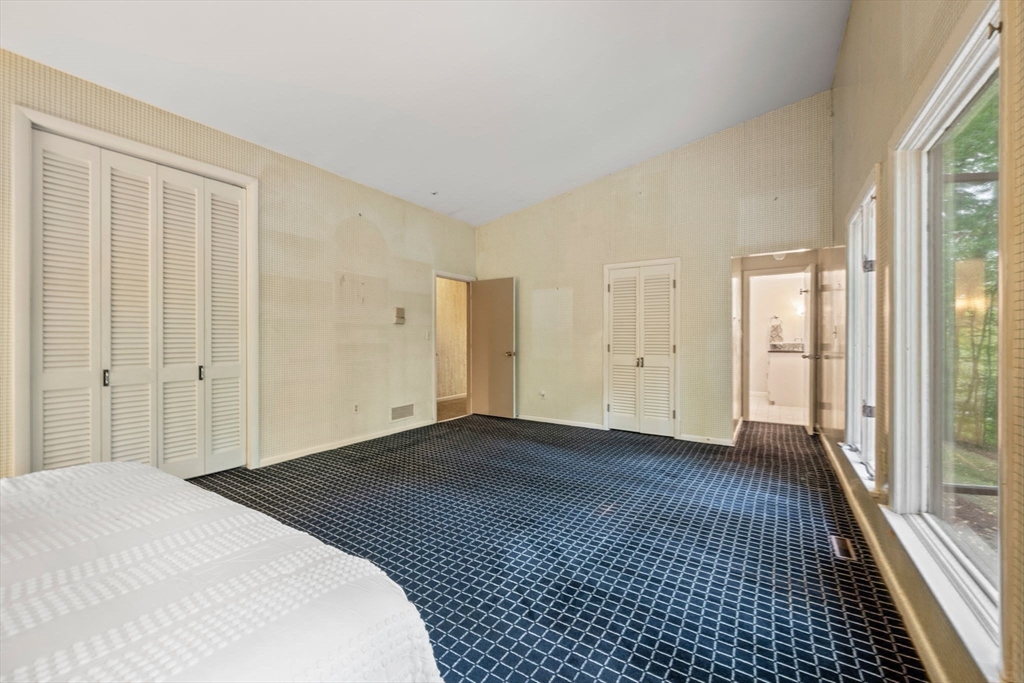 23 Indian Ridge Road Natick, MA 01760 - Photo 7 of 40 a view of a bedroom with wooden floor and windows
