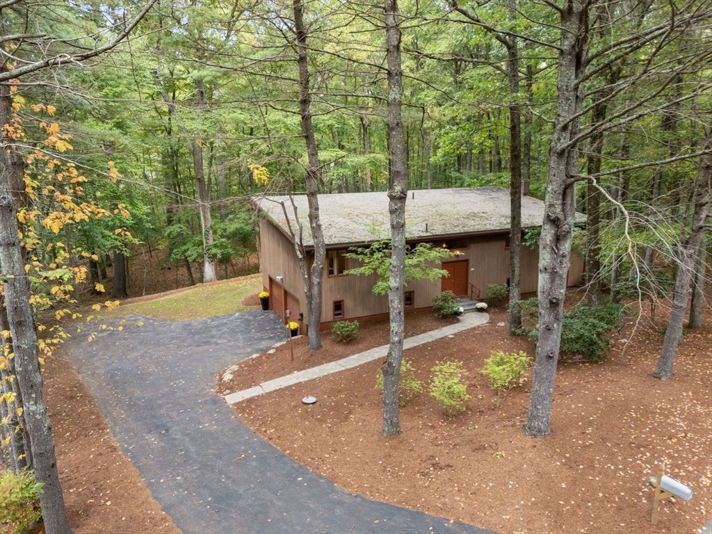 23 Indian Ridge Road Natick, MA 01760 - Photo 10 of 40 a view of a patio with table and chairs with wooden fence and plants