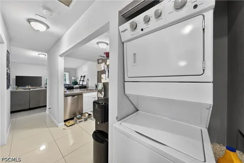 a kitchen with a refrigerator and white cabinets