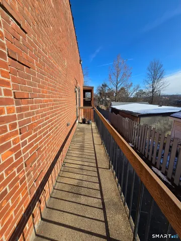 a view of balcony with wooden floor and stairs