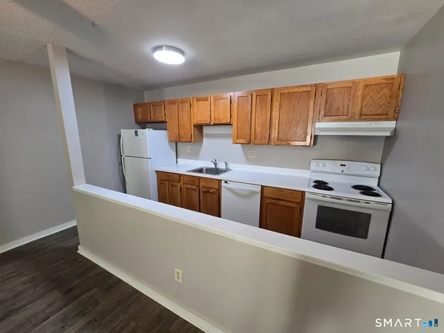 a kitchen with stainless steel appliances a stove a sink and a refrigerator
