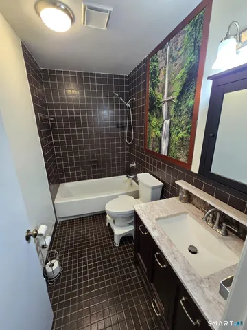 a bathroom with a sink toilet a mirror and shower