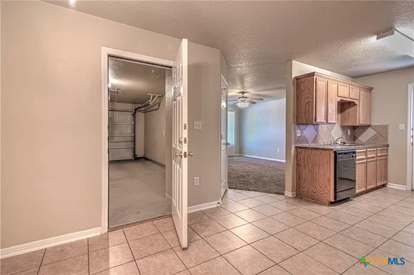 a room with a stove and a refrigerator