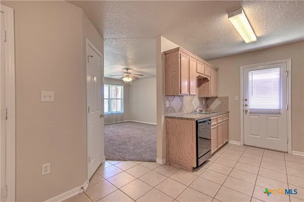 a kitchen with stainless steel appliances granite countertop a refrigerator and a stove