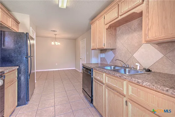 a kitchen with stainless steel appliances granite countertop a sink and a stove