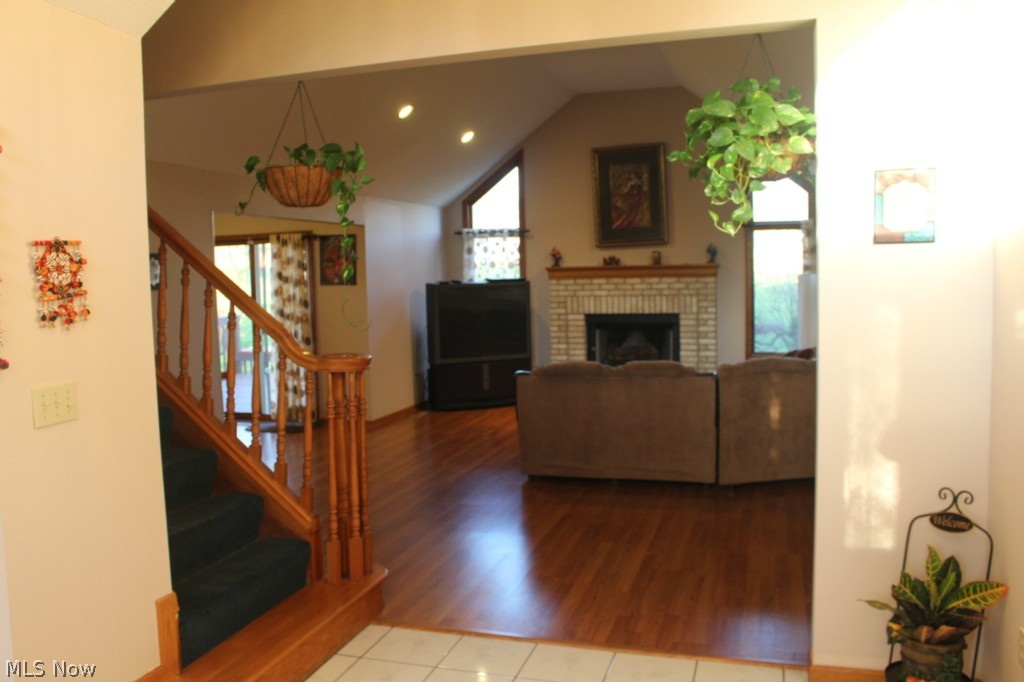 7611 State Road Parma, OH 44134 - Photo 4 of 25 Foyer opens to family room with vaulted ceiling and woodturning fireplace.