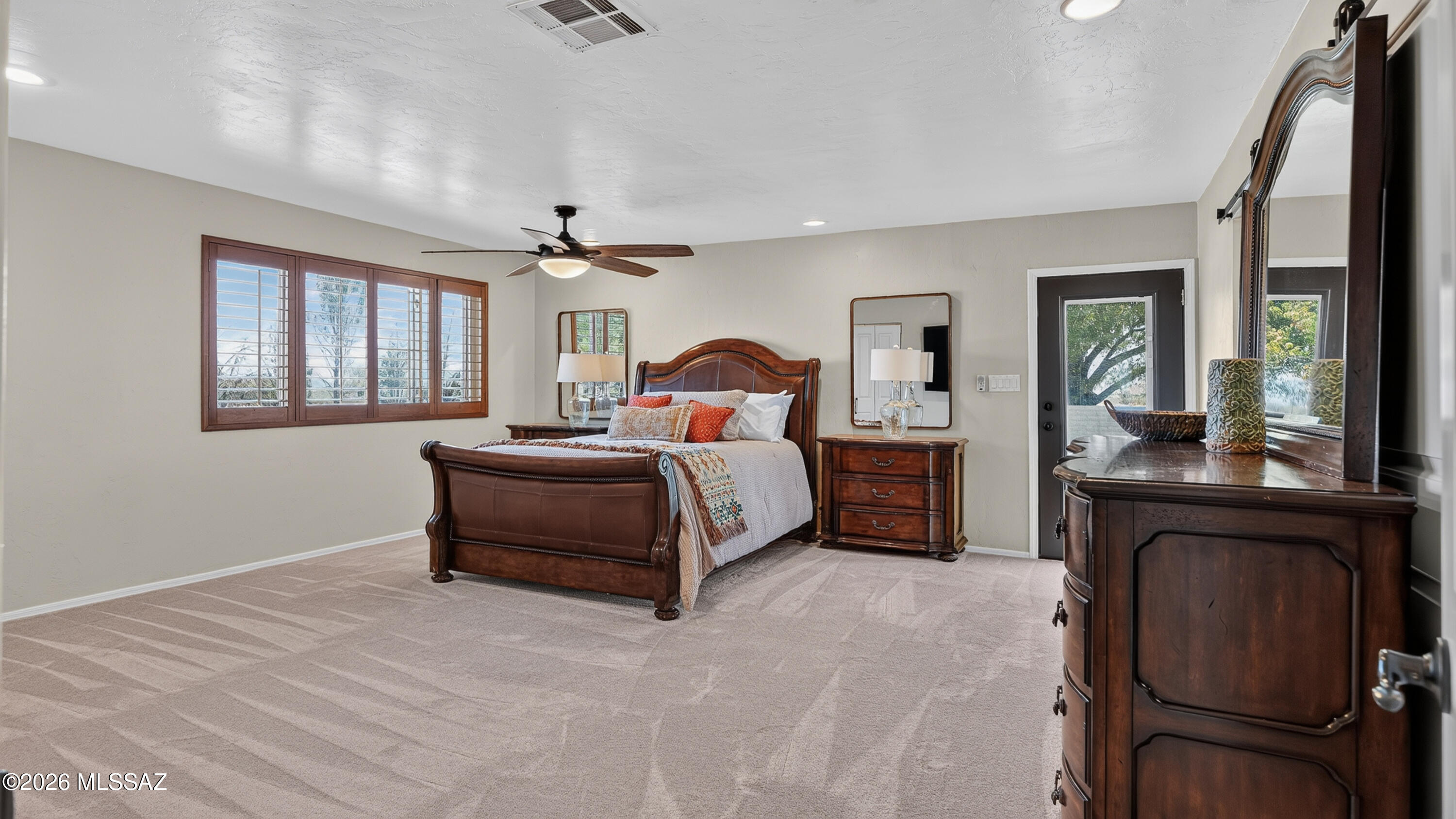 194 Taylor Road Willcox, AZ 85643 - Photo 22 of 54 Primary Bedroom with New Carpet (6.26), Custom Wooden Window Shutters and 2 large Closets, 72" Ceiling Fan and Dimmable Can lighting