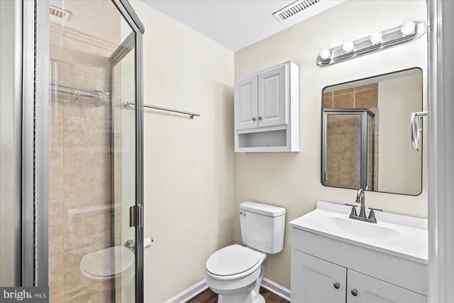 a bathroom with a toilet a sink and a mirror