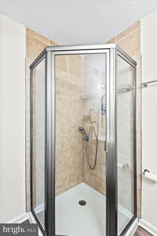 a bathroom with a glass shower door