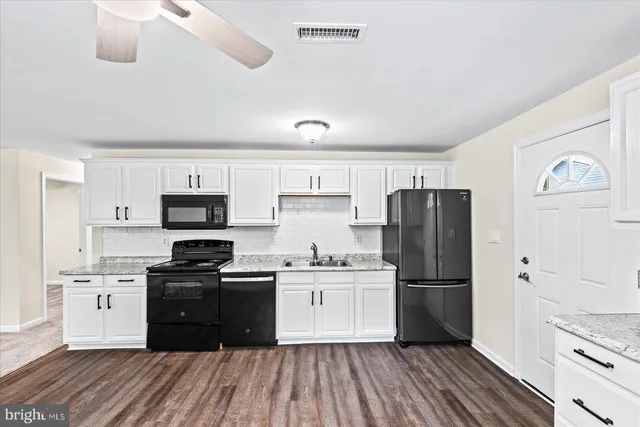 a kitchen with stainless steel appliances a refrigerator stove microwave and sink