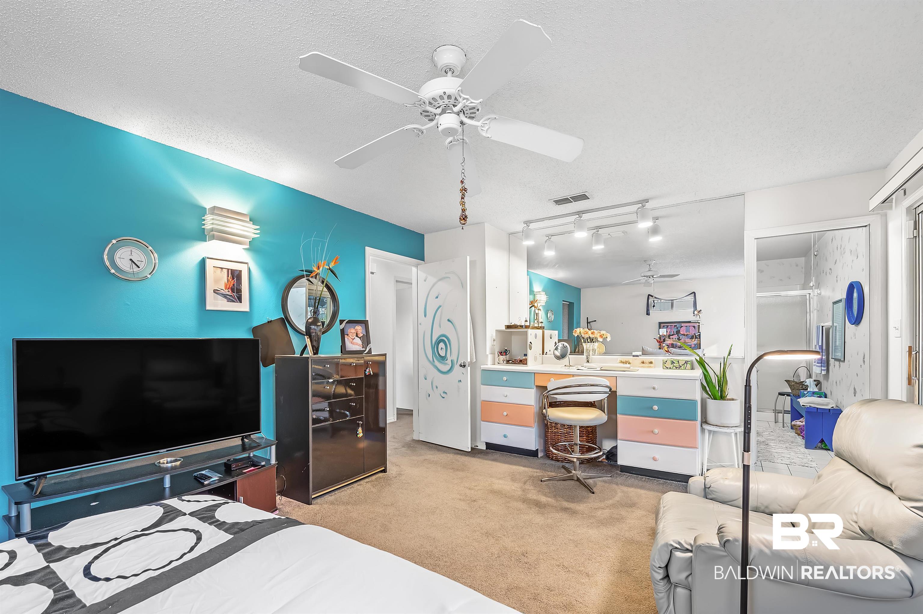 526 Ariel Avenue Foley, AL 36535 - Photo 28 of 33 Carpeted bedroom featuring ceiling fan, rail lighting, and a textured ceiling