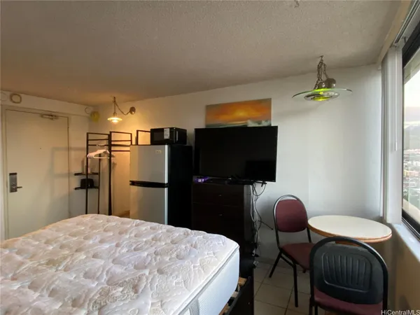 a bedroom with a bed and a flat screen tv