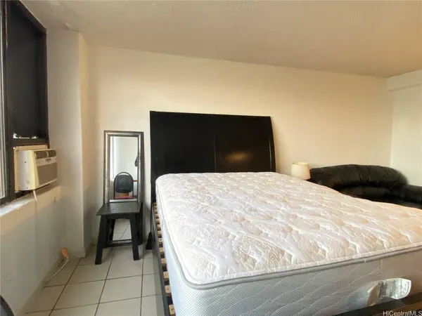 a bedroom with a bed and a television
